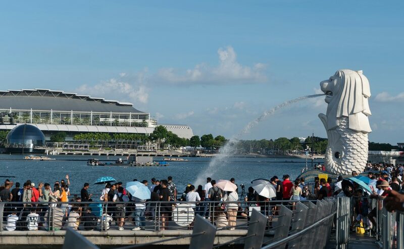 Crowd On Pier By Water Near Merlion, Singapore